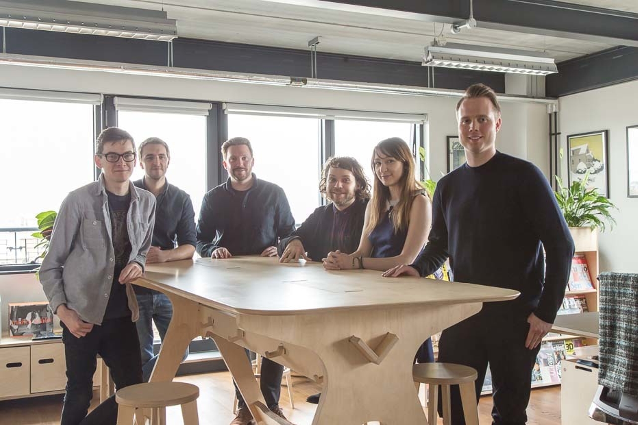 The team gathered around the breakout table